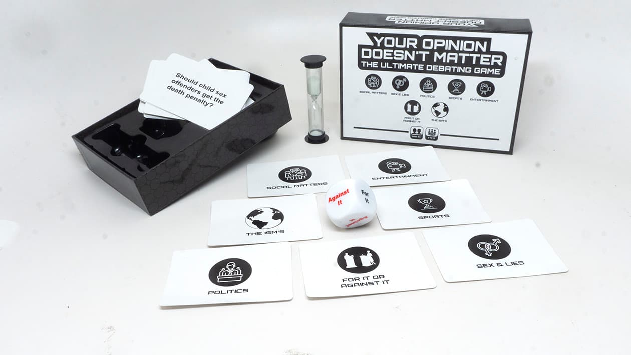 The open YODM box with debate cards, the sand timer, and the die laid out